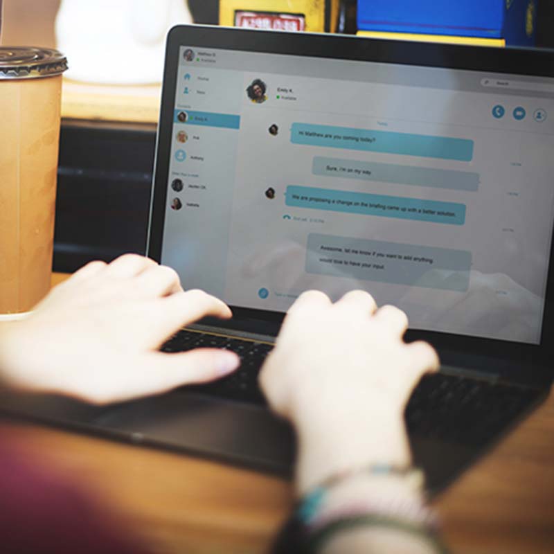 Man using laptop to chat with friends